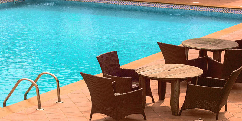 A pool with table and chairs.