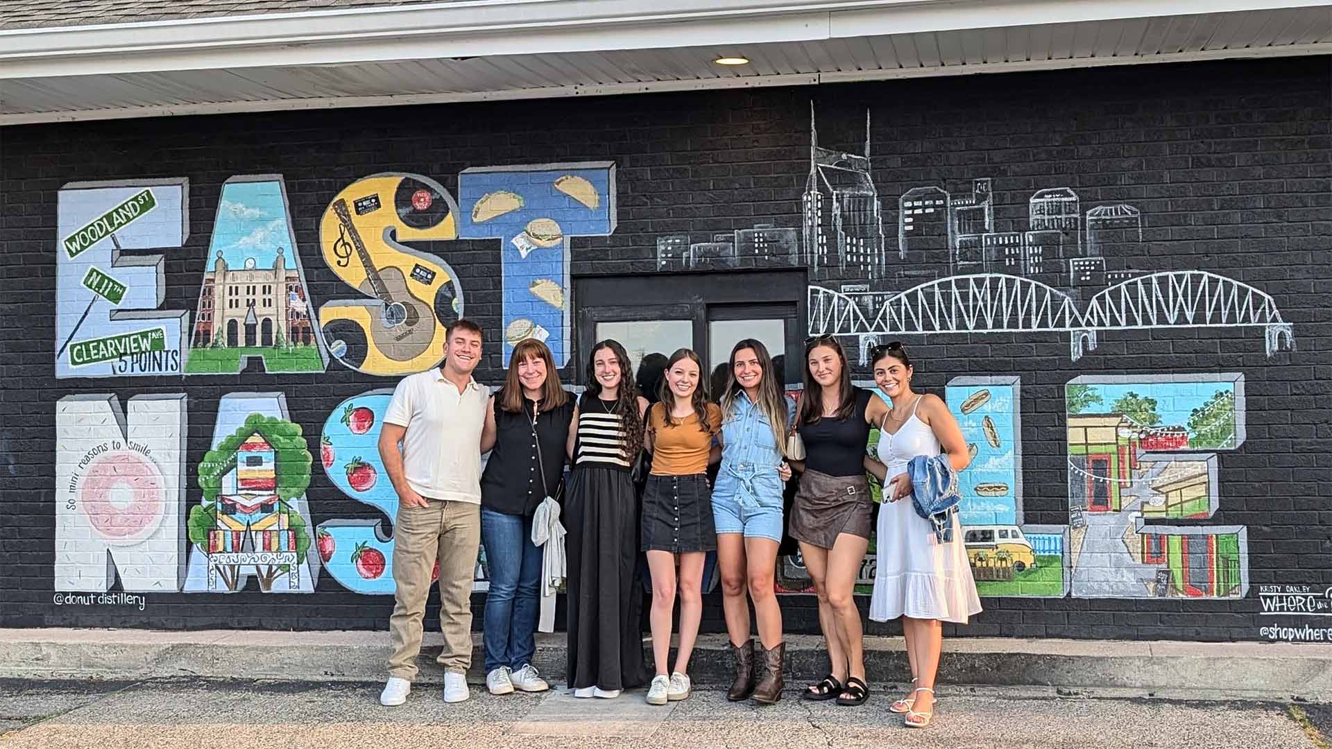 Clyde Paul team posing in front of an East Nashville mural