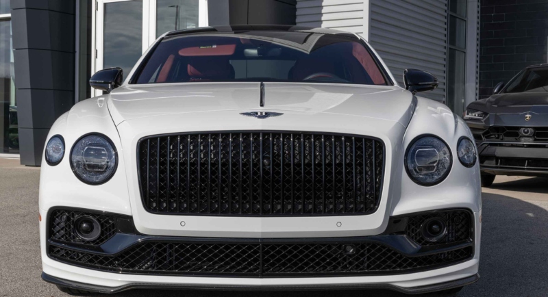 An expensive white car facing forward.