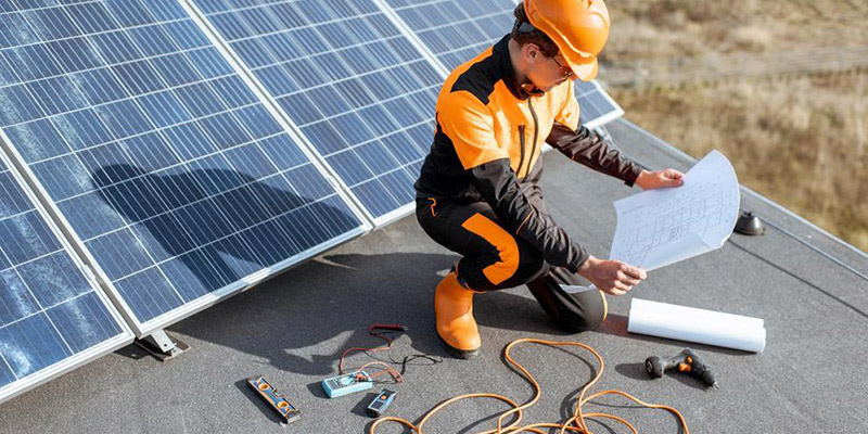 A photo of an electrical contractor installing solar panel roofing.