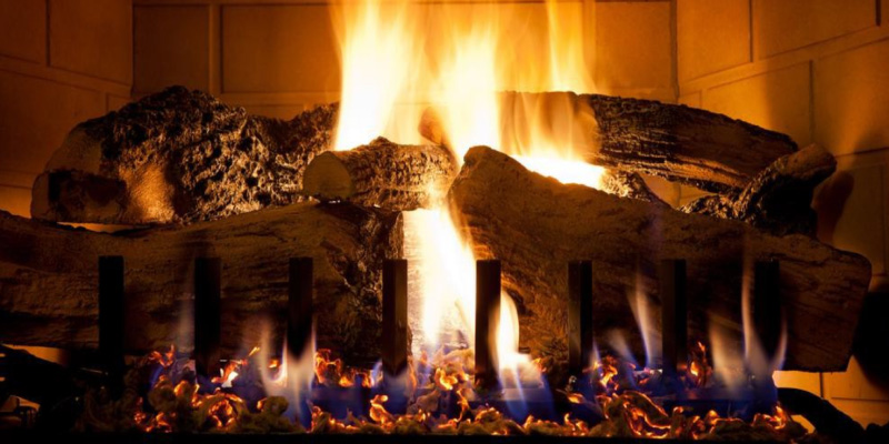 Cozy wood-burning fireplace with bright flames and safety tips for home heating